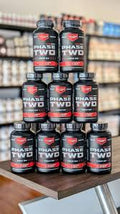 Optimus Jack Phase Two: mehrere Flaschen mit rotem „Phase Two“-Etikett, dicht gestapelt